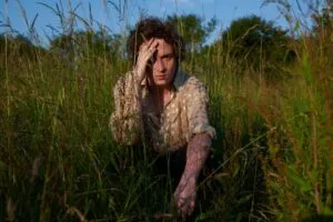 Persoon in hoog gras op zonnige dag